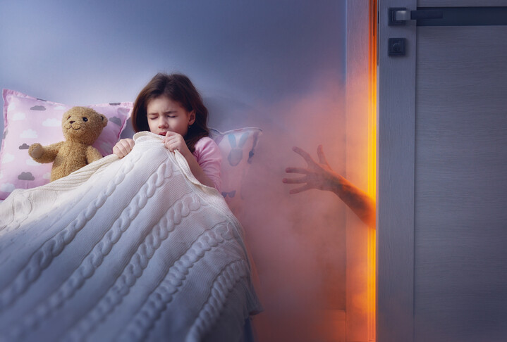 child in bed having nightmare scared by creepy fairy tales